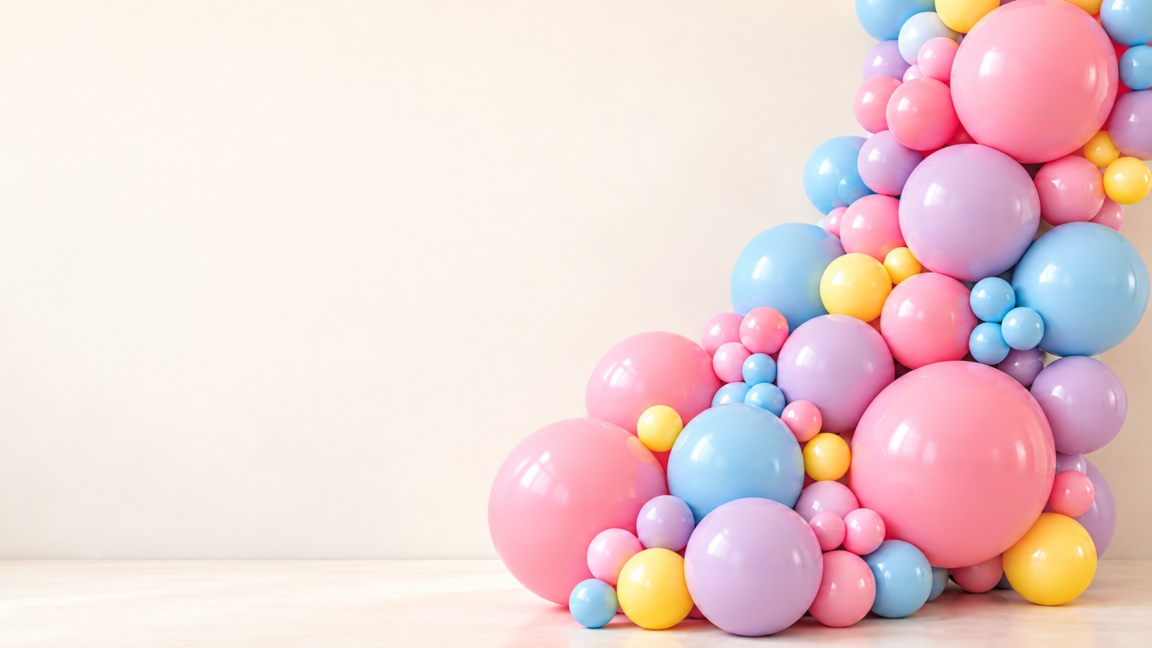 Pastel balloon garland on a cream background